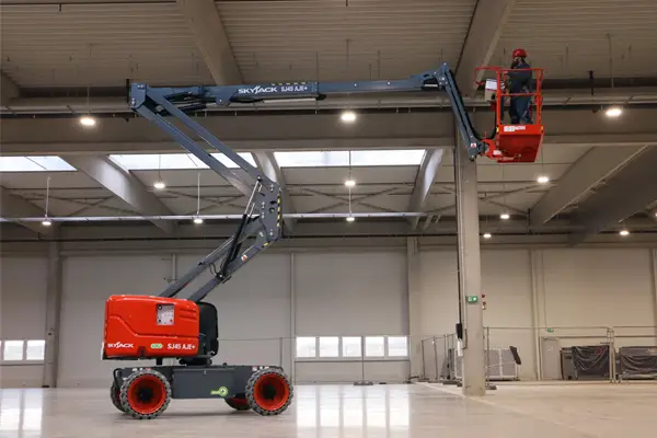 Skyjack hybrid diesel-electric articulated boom lift supplied by QuoteMeHire for safe elevated access in warehouses and industrial sites across the UK.
