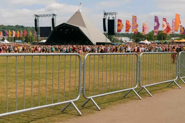 Crowd control barriers linked together at an outdoor event for temporary site and event security.