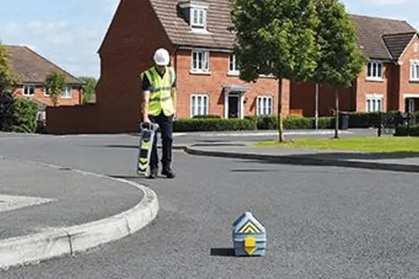 Cable avoidance tool and signal generator used on a construction site to locate buried cables before excavation.