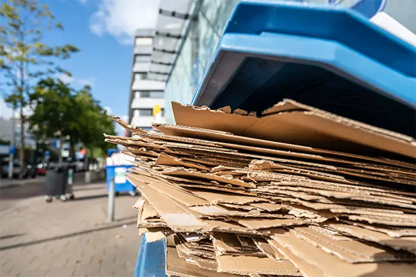 Cardboard neatly stored on site ready for disposal or compaction as part of waste recycling management.