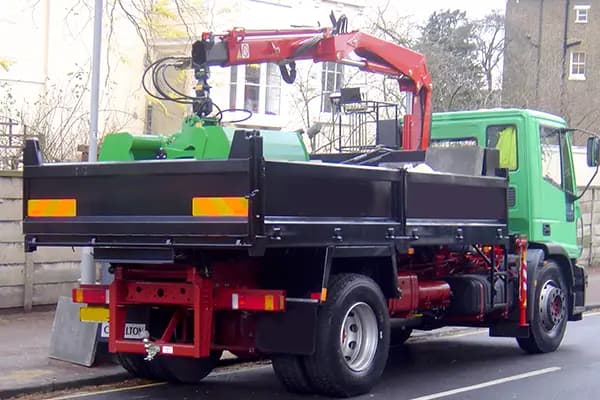 Grab wagon removing mixed construction waste from a site as part of waste management services.
