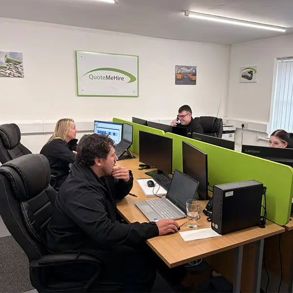 Quote Me Hire team at their desks in the office providing expert access hire support and customer service